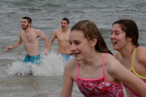 Swimers Margaret Strehle, Kristin Saleski, TJ Winer and Grant Juric run out of the water. 