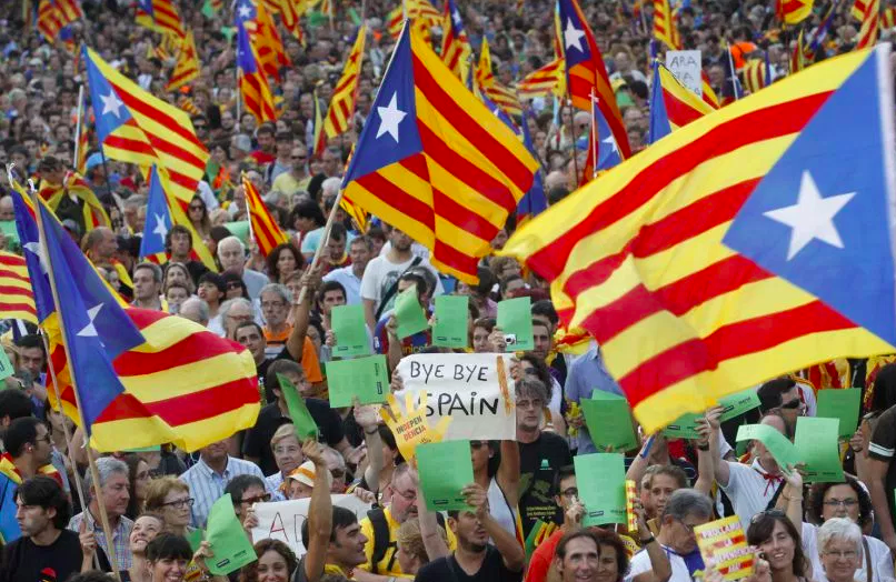 People+demonstrating+in+Barcelona+in+favor+of+Catalan+independence+with+the+Catalonia+flag+and+%22bye%2C+bye+Spain%22+posters.+%28Photo+from+The+Nation%29.