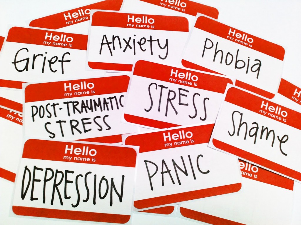 A pile of name tags with mental disorders written in place of names, emphasizing the ways in which society unfairly defines mentally ill people by their illnesses.