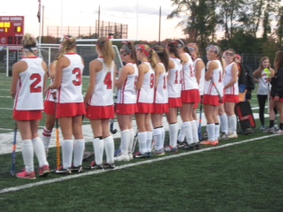 Hingham girls watching their teammates from the sideline.