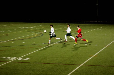 Aiden Ryan outruns the other team to get the ball.