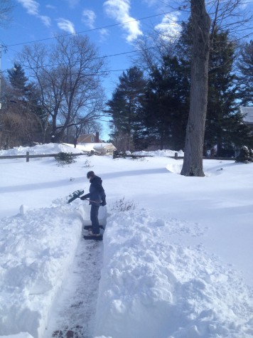 Hingham resident Tim Dwyer shovels a walkway.