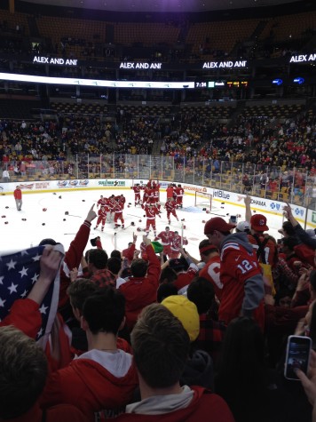 The players skate over to celebrate with their fans.