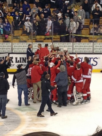 The team celebrates with the trophy.