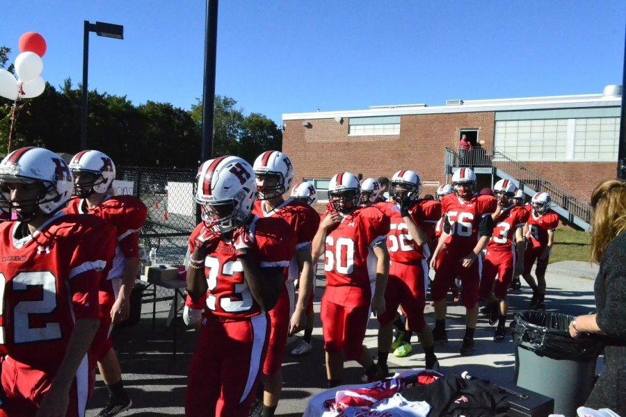 The football team walking onto the field for their three o’clock game against Silver Lake