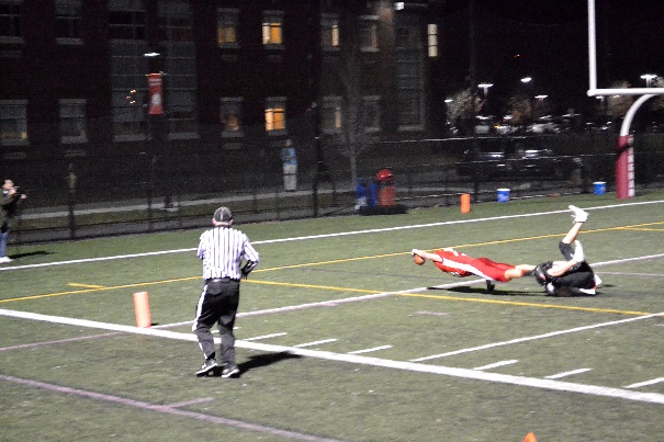 A quick tackle is not enough to prevent this player from completing a successful touchdown.