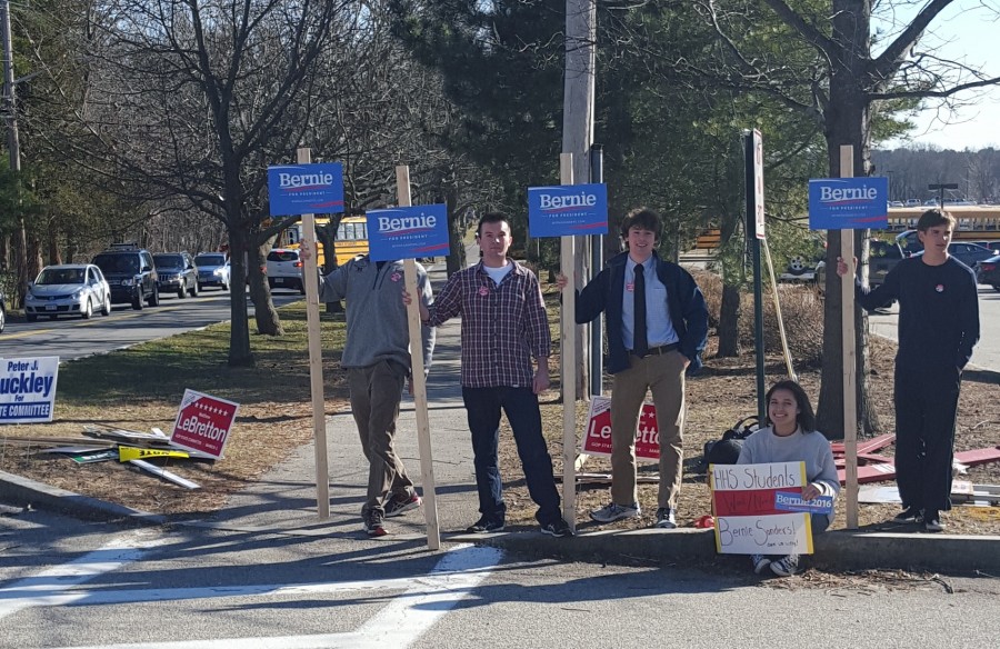 (Left to Right) Seniors Collin Parker, Ryan Parker, sophomore Brendan Chase, and seniors Lulu Wiley and Chris Curran hold signs for Democratic candidate Bernie Sanders. 