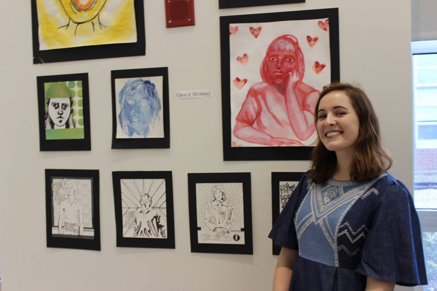 Senior Grace Murray poses next to her artwork.