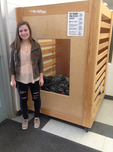 Julia Murphy proudly displays her donation bin in the HHS lobby.