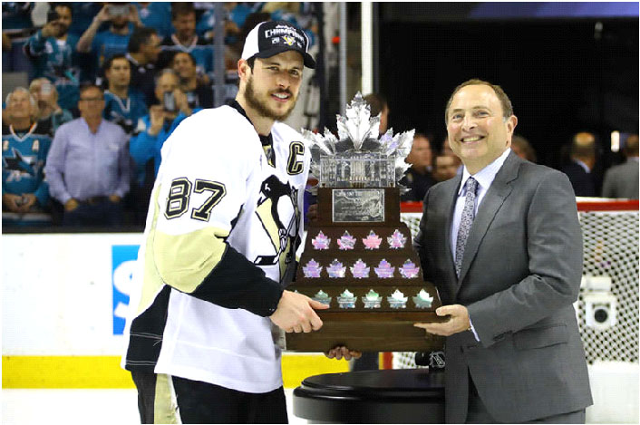 Captain Sidney Crosby poses with the Conn Smythe Trophy and NHL Owner Gary Bettman.