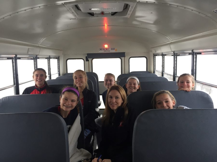 The bus ride home, athletes and coach Diedricksen are all smiles from a successful day. 