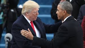 Former President Barack Obama shakes hands with President Donald Trump.