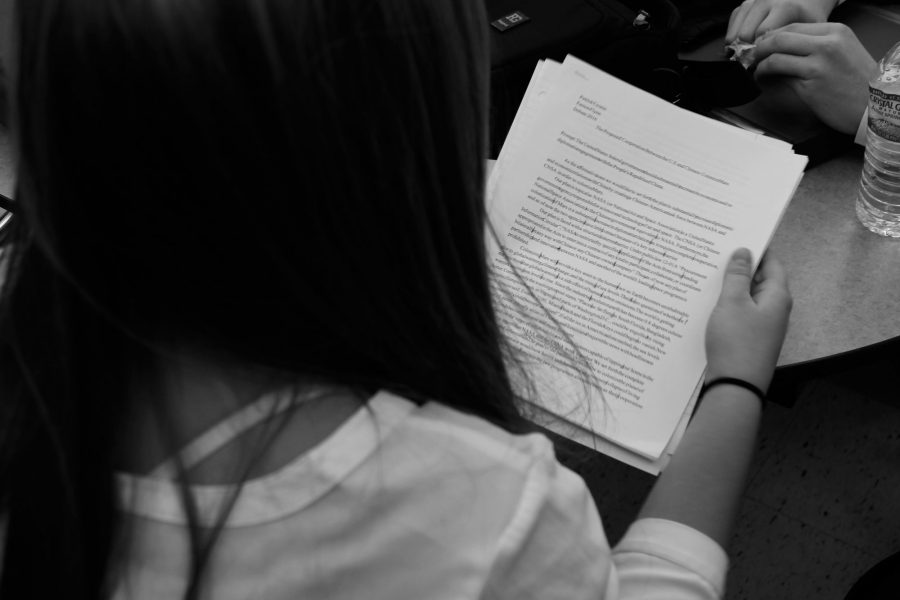 Sophomore Perrin OCone reads over her affirmative plan. The Novice Debater explained, Debate is a lot of fun, but I dont think people realize how much work it is. My partner Nina and I have spent countless hours at the library working on our plan...