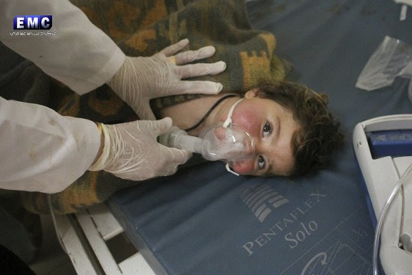 A young Syrian boy being treated by a doctor at a make-shift hospital following the devastating chemical attack.