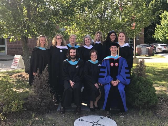 Laney Silva and members of the English Department pose before graduation.  