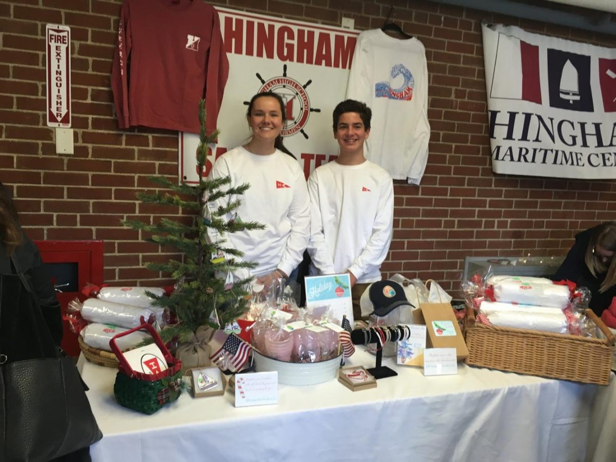 Juniors Grace Gruber and Robbie Briggs representing the Sailing Team table on Saturday morning. 
