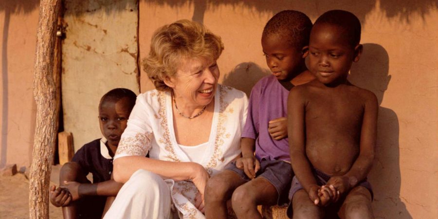 Ann Cotton of Camfed International smiling with some of the children she met during one of her trips to Africa.