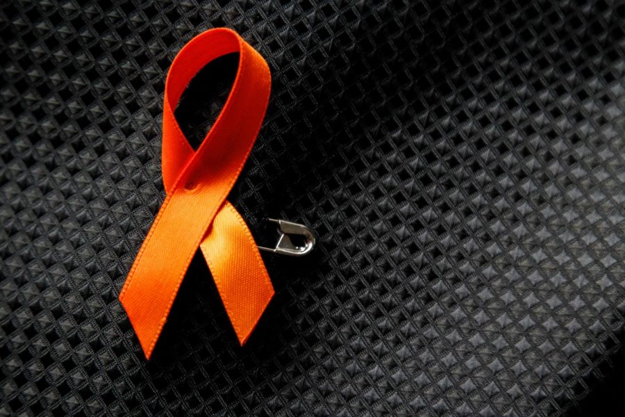 Attendees donned orange ribbons in honor of Andrew Warhaftig; pictured here pinned to the vest of Junior Nick Thompson.