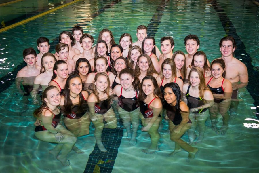 Members of Hingham High Schools swim team pose for a team photo in the Connell Pool in Weymouth. Photo by Andrew Mariner