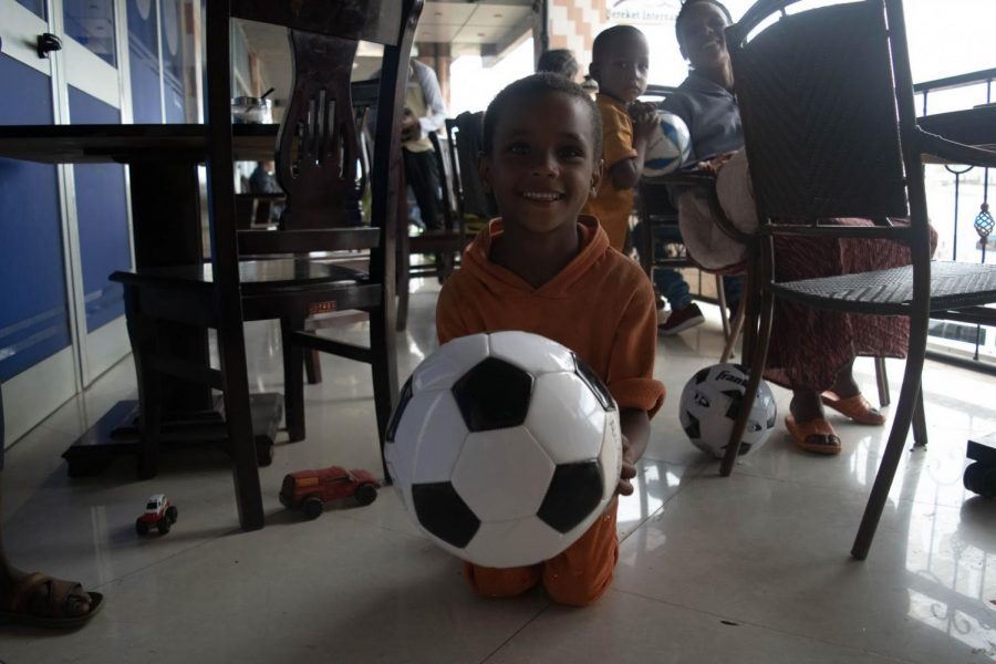 Abuti, Dagim, and Mamush playing with toy cars and soccer balls for the first time.