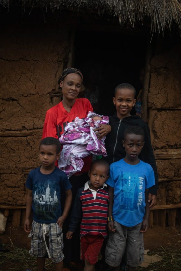 From the right, Dagim, Mamush, and Buti. In the back is birthmother (Abaynesh), baby Bereket, and Yeshak all in front of the Families hut.