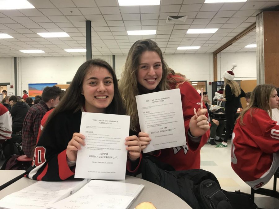 Seniors Gianna Merian and Aine Powell smile with their superlative voting forms.