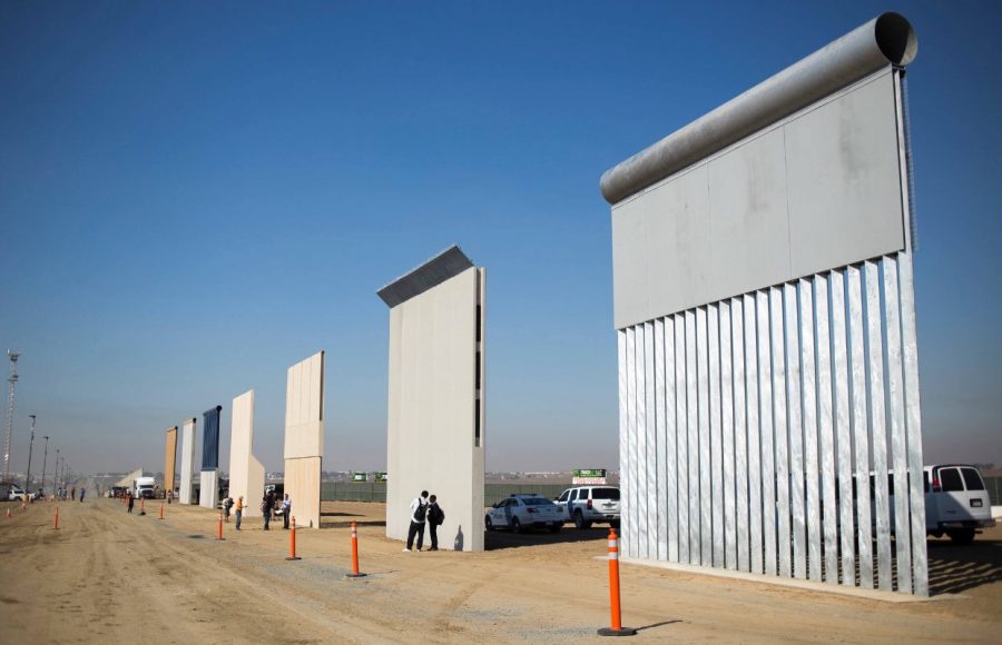 A display showing prototypes of the border wall. (Jenna Schoenefeld / The New York Times)