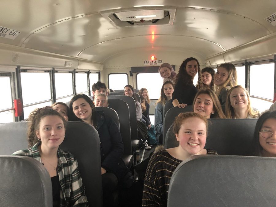 The eighteen delegates from HHS smile as they ride the but to the HMUN conference on Thursday, January 24th.