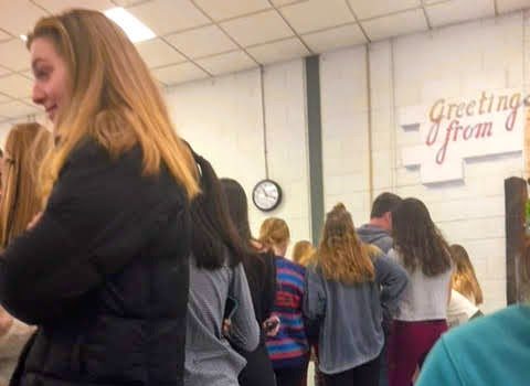 Students line up in the cafeteria to purchase rose and candy package for their friends before Valentines Day.