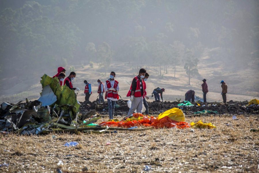 Rescuers clean and look through the site of the Ethiopian Airlines Flight 302 crash. (Mulugeta:Associated Press)