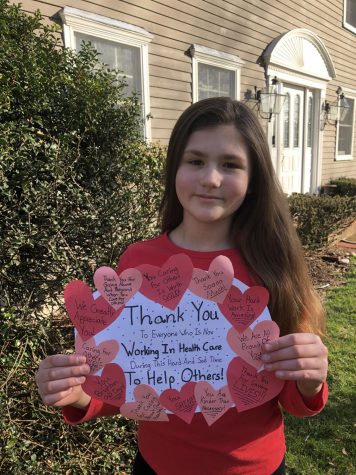 Fifth grader and Harborlight contributor Vivianne Kust holds up th sign of gratitude she made during this quarantine.