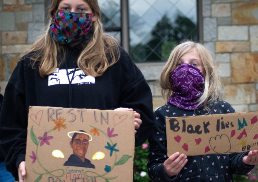 Freshman Bridget Foley and her sister held signs at the vigil.