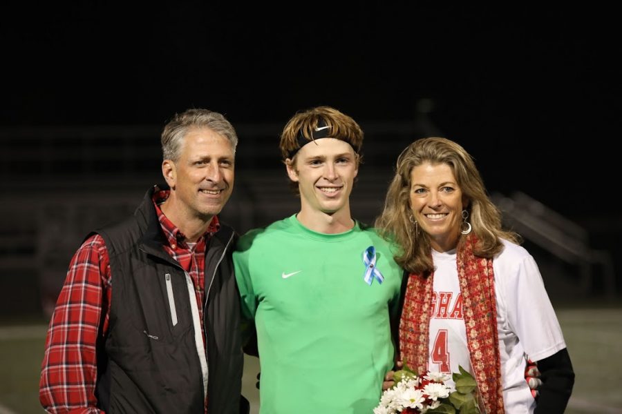 Then, Goalie, Senior Trent Hesselman takes the center field with mother and father.