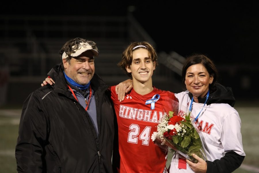 Senior Cole Laping follows with mother and father.