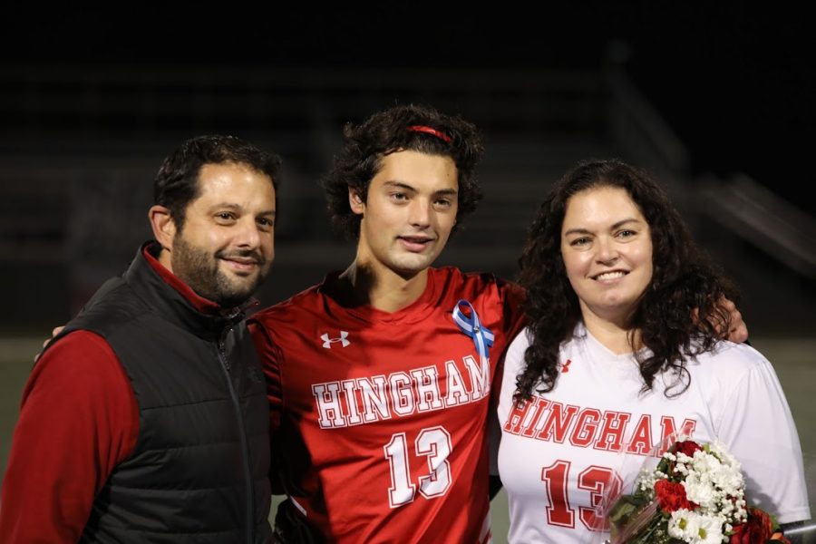 Senior Joey Prestia follows with mother and father.