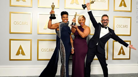 Mia Neal, Jamika Wilson, and Sergio Lopez-Rivera celebrate for a photo, holding their Oscars they won for best makeup and hairstyling.