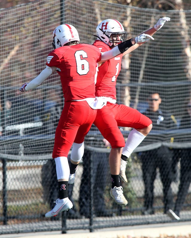 Hingham receivers Henry Crean and Nick OConnor celebrate the first score of many in their victory over Scituate while in the end zone.