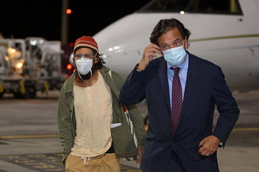 Danny Fenster (left), exiting the a plane at Hamad International Airport in Qatars capital Dohawith with former U.S. diplomat Bill Richardson (right) after being released from Myanmar prison  on Monday. 