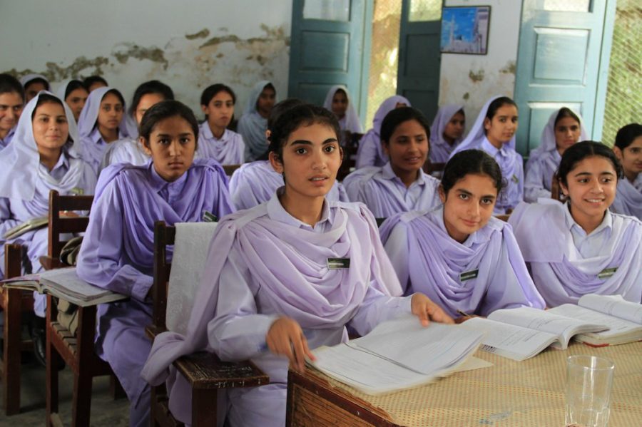 Girls congregate in Pakistan where nearly 56% of the 22.6 million children are not in school.