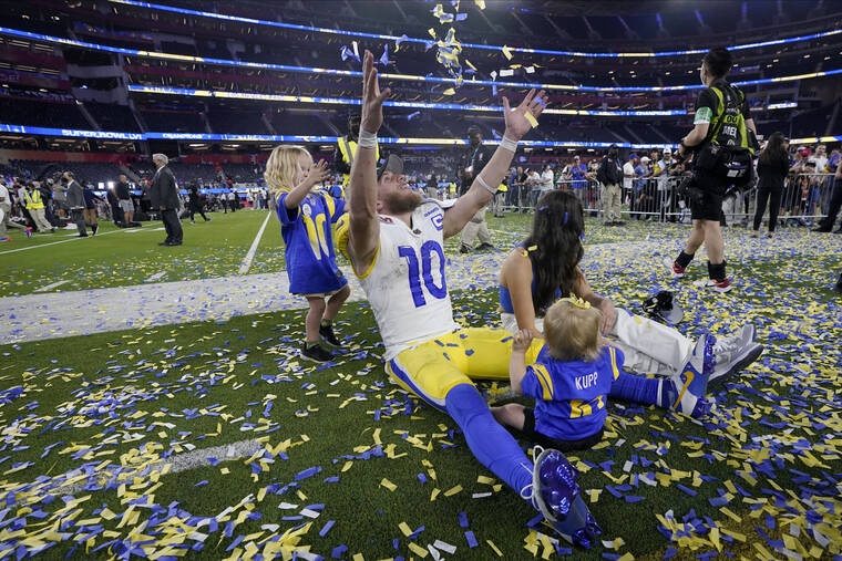 Super Bowl MVP Cooper Kupp celebrates the Rams Super Bowl win on Sunday with his wife and two children. 