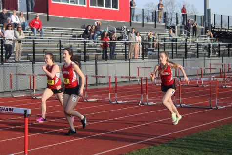 (From left to right) senior Alex Denning, sophomore Mary Claire Walsh, and sophomore Isabel McCabe compete in the girls 100m hurdles.