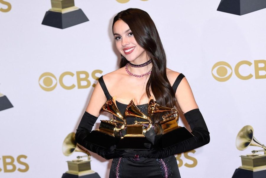 Olivia Rodrigo poses with her three Grammy Awards 