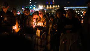 People of small-town Moscow, Idaho honor the deceased students in a silent gathering. 