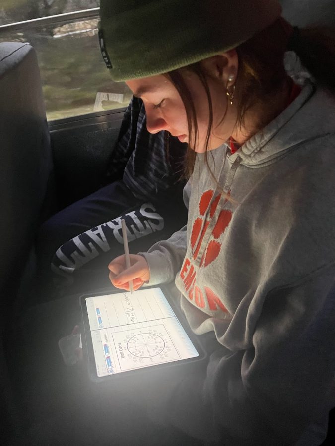 Junior Anna Kiernan studying hard for her math exam on the way to her ski team practice at Blue Hills.
