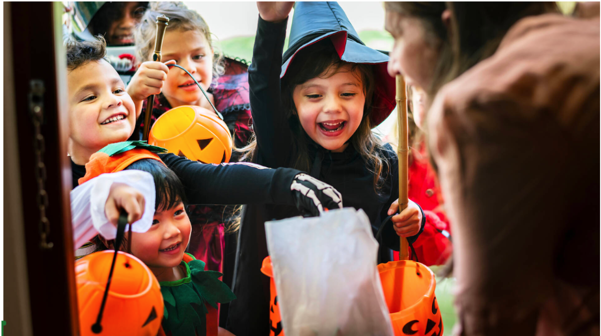 Kids in popular costumes reaching for candy while trick-or-treating .
Shutterstock/Rawpixel.com

