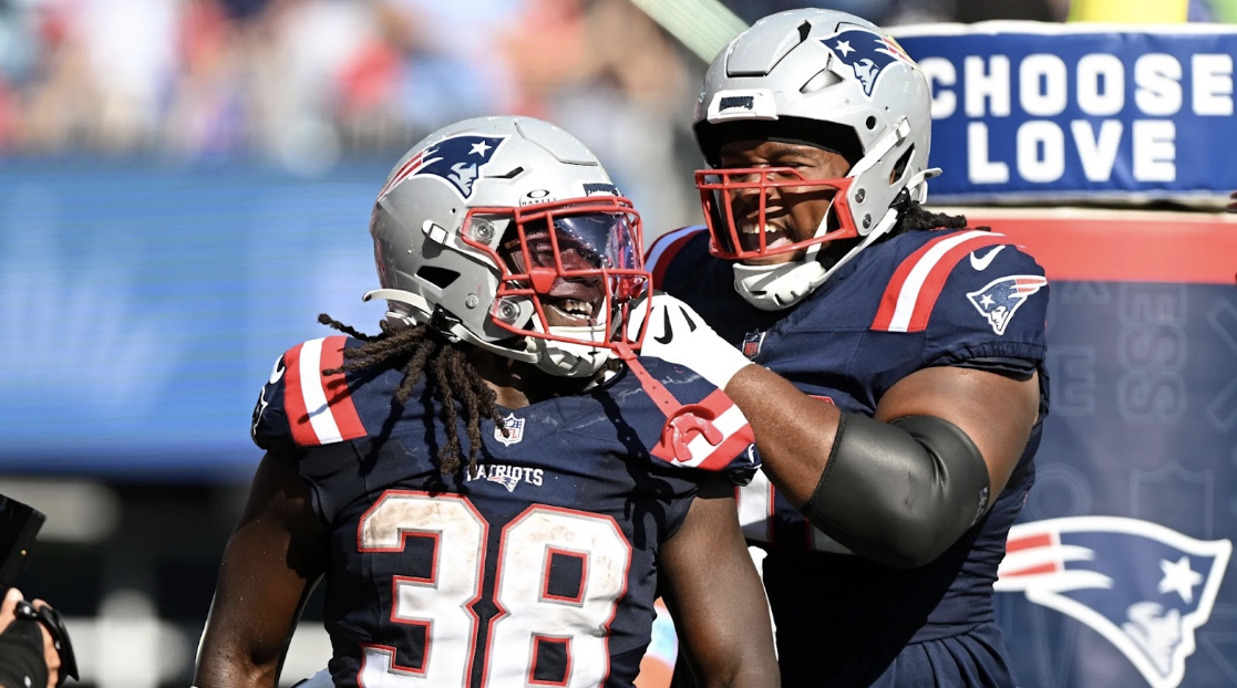 Running back Rhamodre Stevenson (38) celebrating with offensive linemen Caden Wallace (70) after a touchdown. 