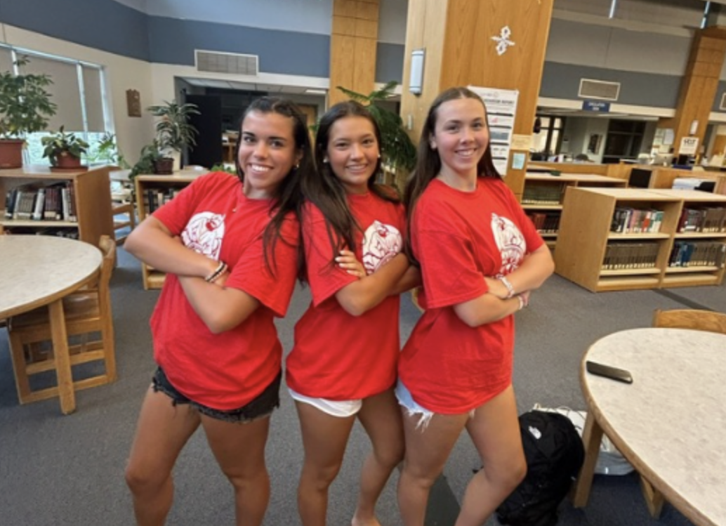 Senior students posing in library where Monday meetings of Homework Club takes place.