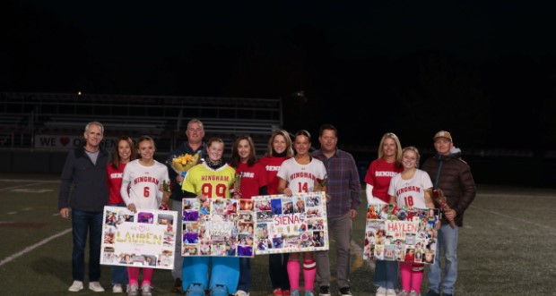 Picture of the Seniors, Lauren Howard, Becca Kardoos, Siena Brackett, and Haylen Wilson  and their parents at the senior night Field Hockey game.
