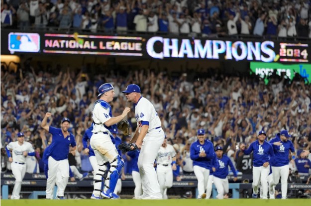 Dodgers pitcher Blake Treinen and catcher Will Smith celebrate the final out of game six of the NLCS (AP Photo/Julio Cortez). 