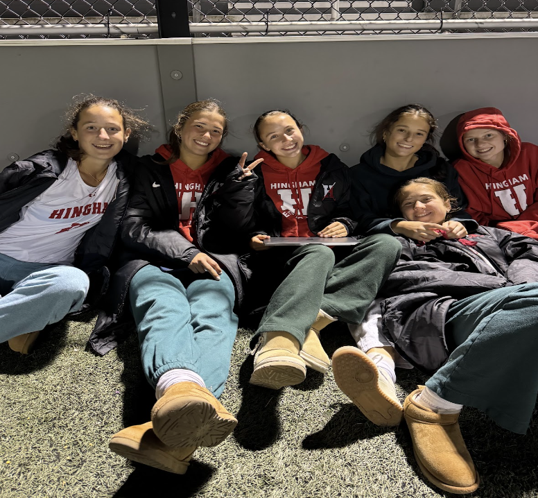 Members of the Hingham field hockey team spend time together after their game.